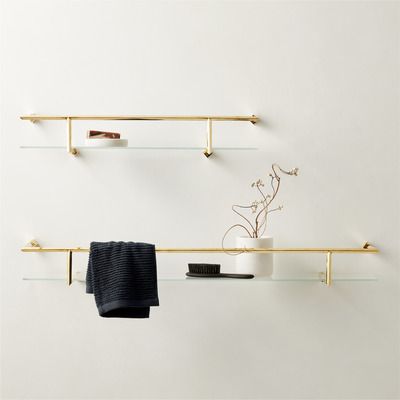two gold floating shelves styled with a hand towel and soap